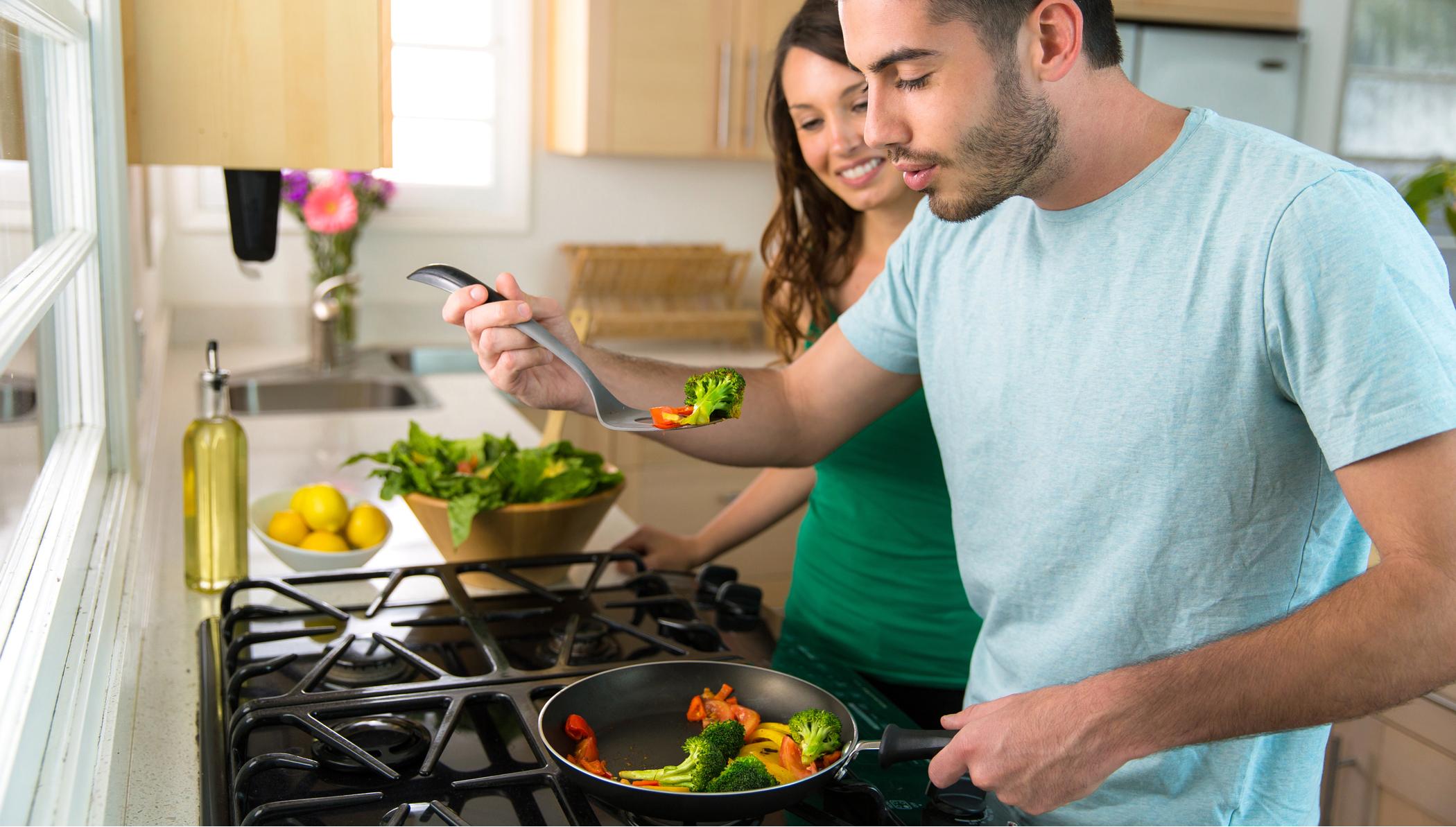 couple cooking at stove